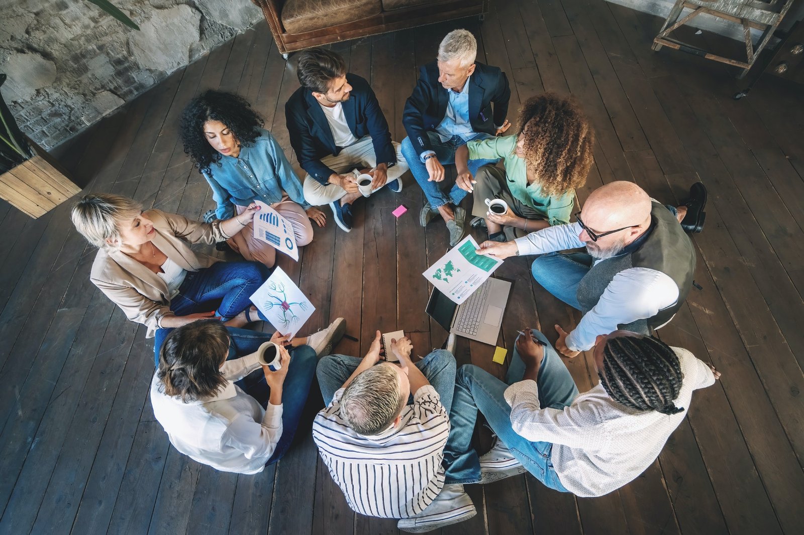 Multi-ethnic Team Brainstorming on Rustic Wooden Floor