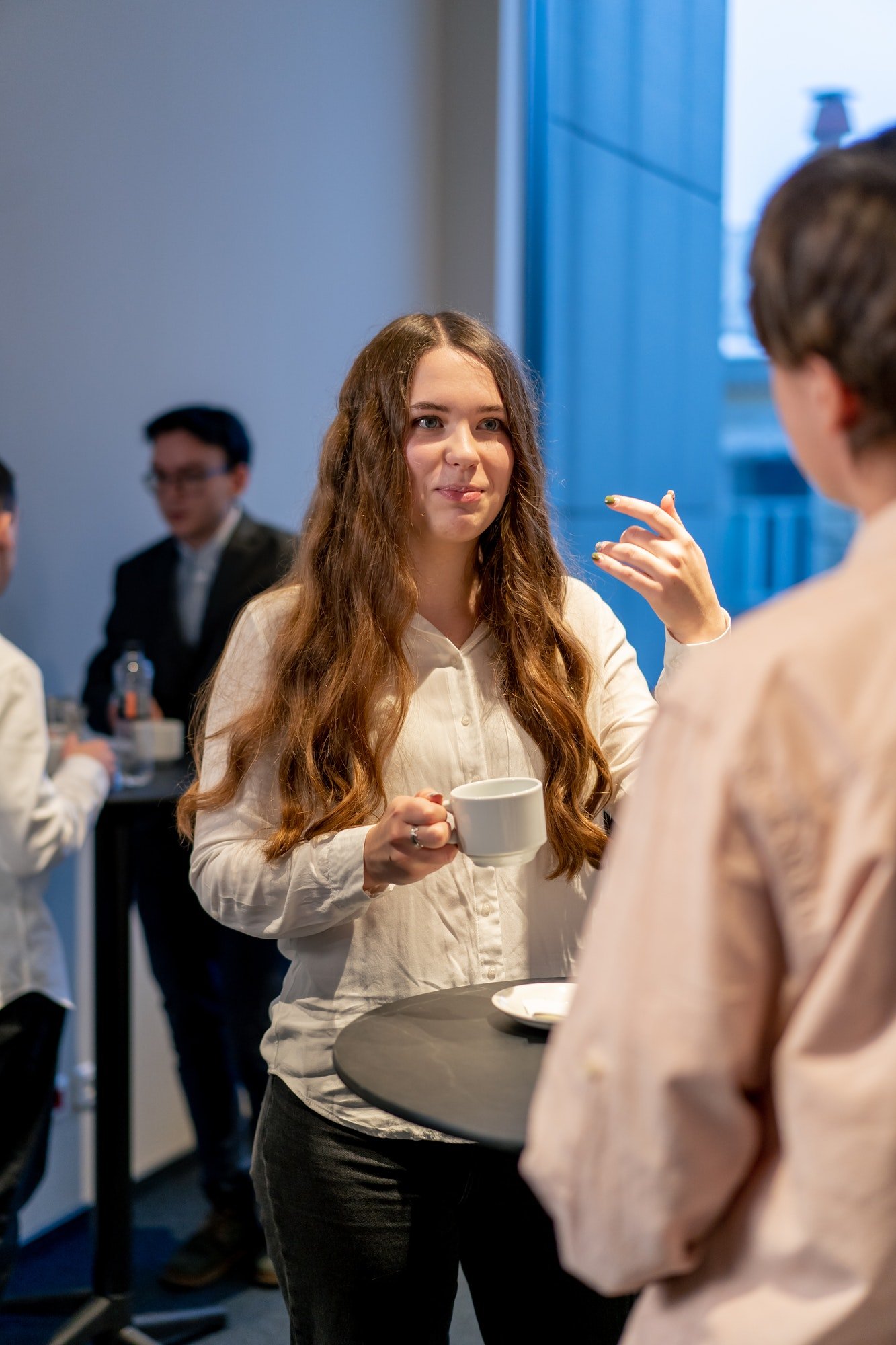 people at business conference drinking coffee and chatting during coffee break networking